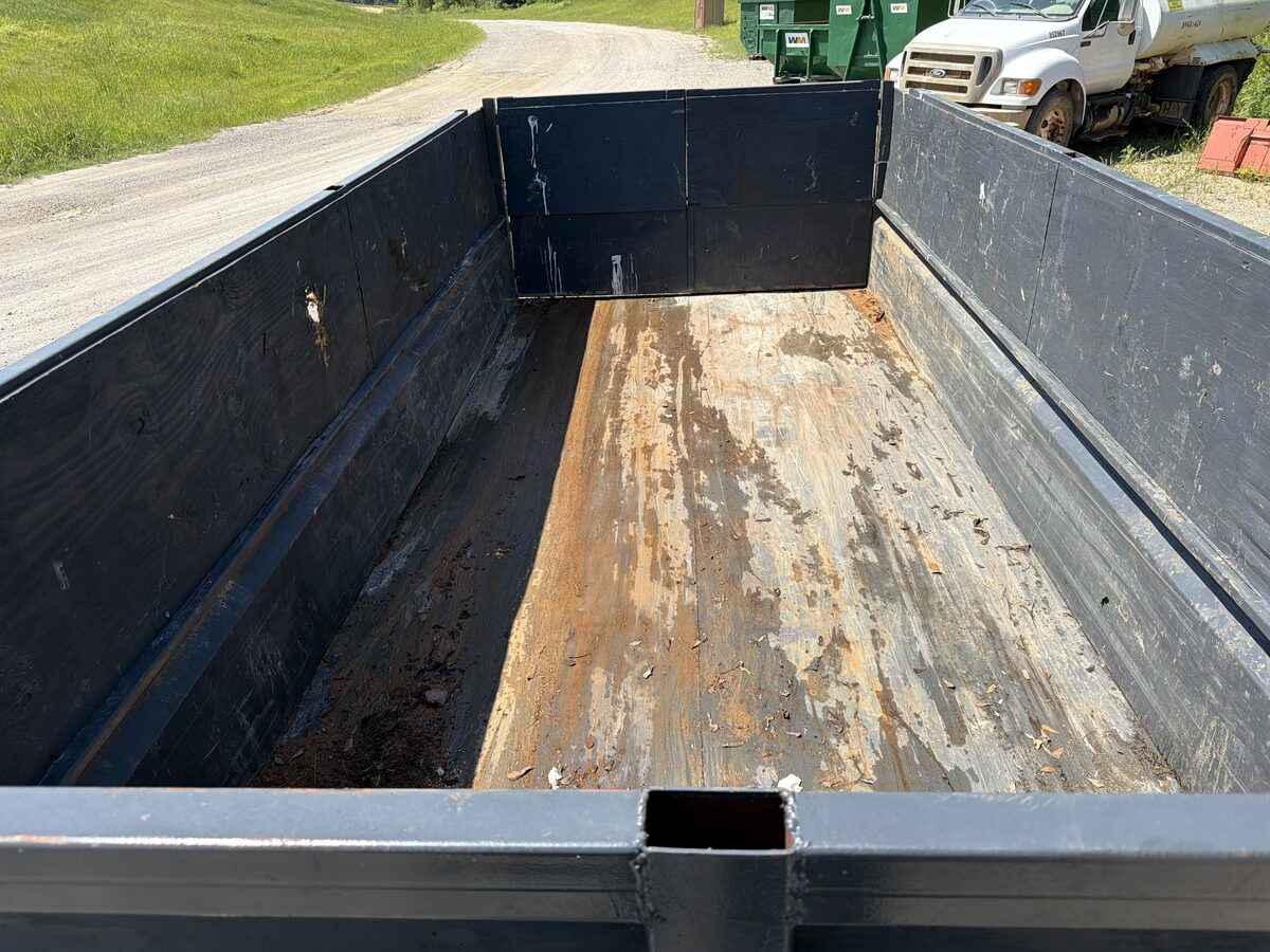 Empty black dump trailer ready for a cleanup project