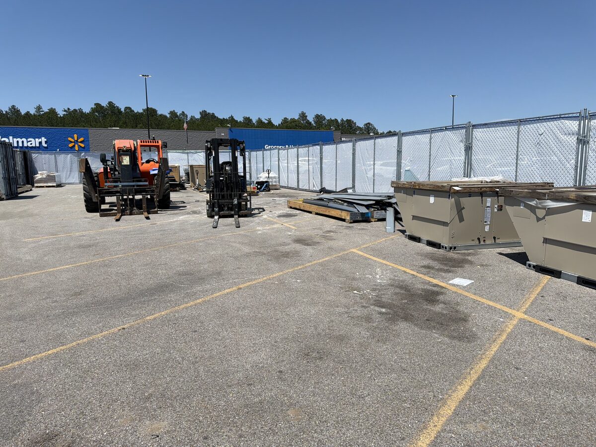 Multiple dumpsters positioned for a commercial property cleanup project